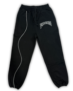 Black sweatpants with white piping and logo on a white background